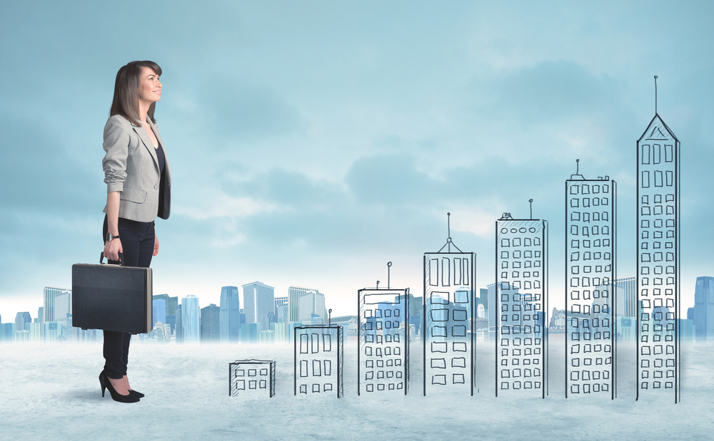 Business woman climbing up on hand drawn buildings in city concept Business woman climbing up on hand drawn buildings in city concept