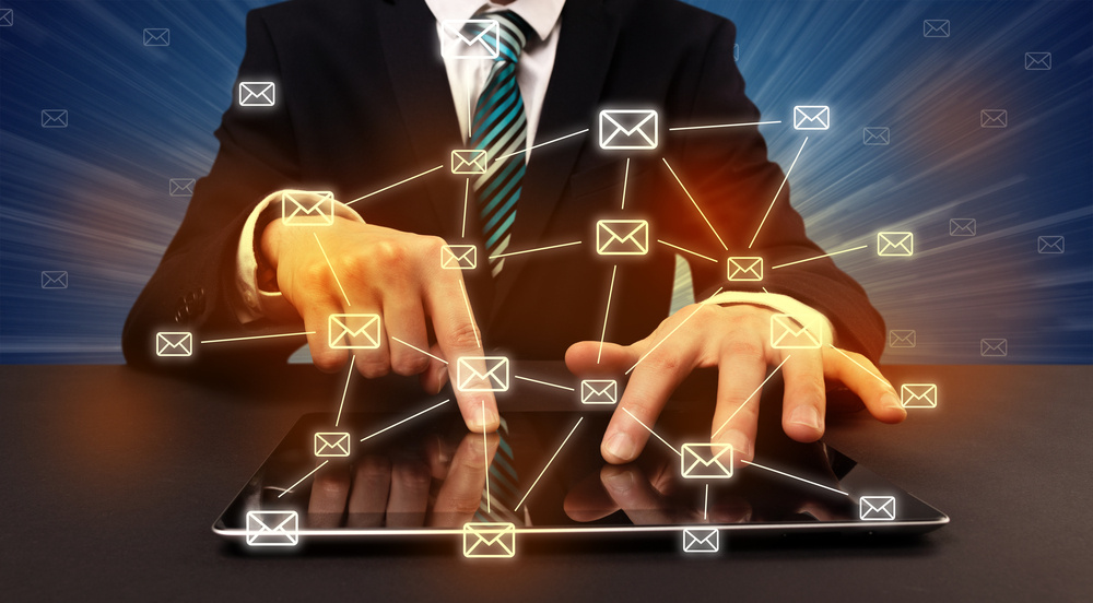 Businessman in suit typing with connected mail icons around Businessman in suit typing with connected mail icons around