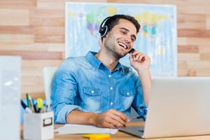 Handsome travel agent speaking with customer in the office-1