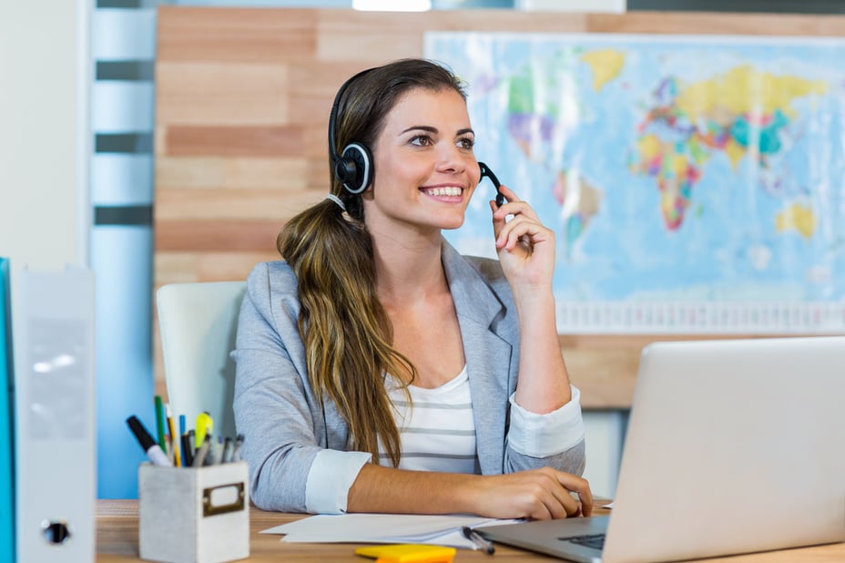Pretty travel agent speaking to customer in the office Pretty travel agent speaking to customer in the office