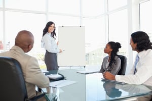Young businesswoman giving a presentation while her colleagues are listening to her